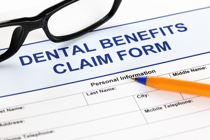 Patient checking their insurance benefits for dental implants