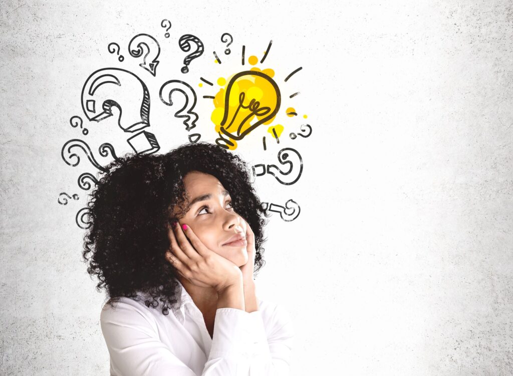 Woman leaning chin on hands with animated question marks and light bulb over her head